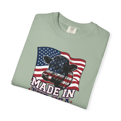Rancher T-Shirt featuring a cow graphic with American flag design, representing patriotic American pride apparel.