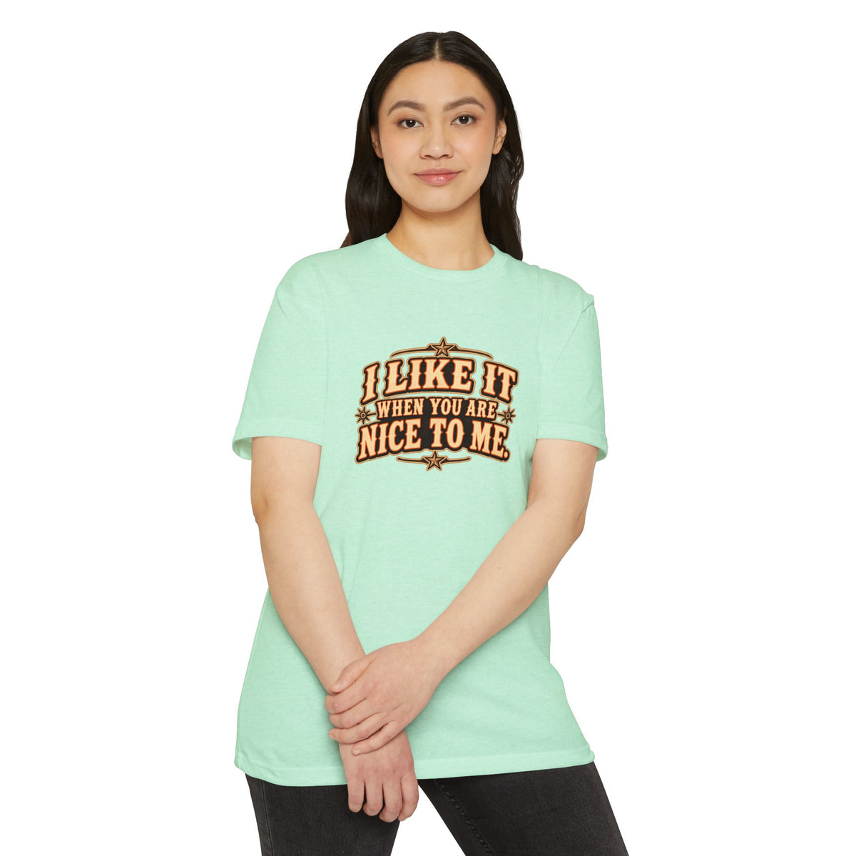 Model wearing the I Like It When You Are Nice To Me T-Shirt in mint green with retro graphic design.