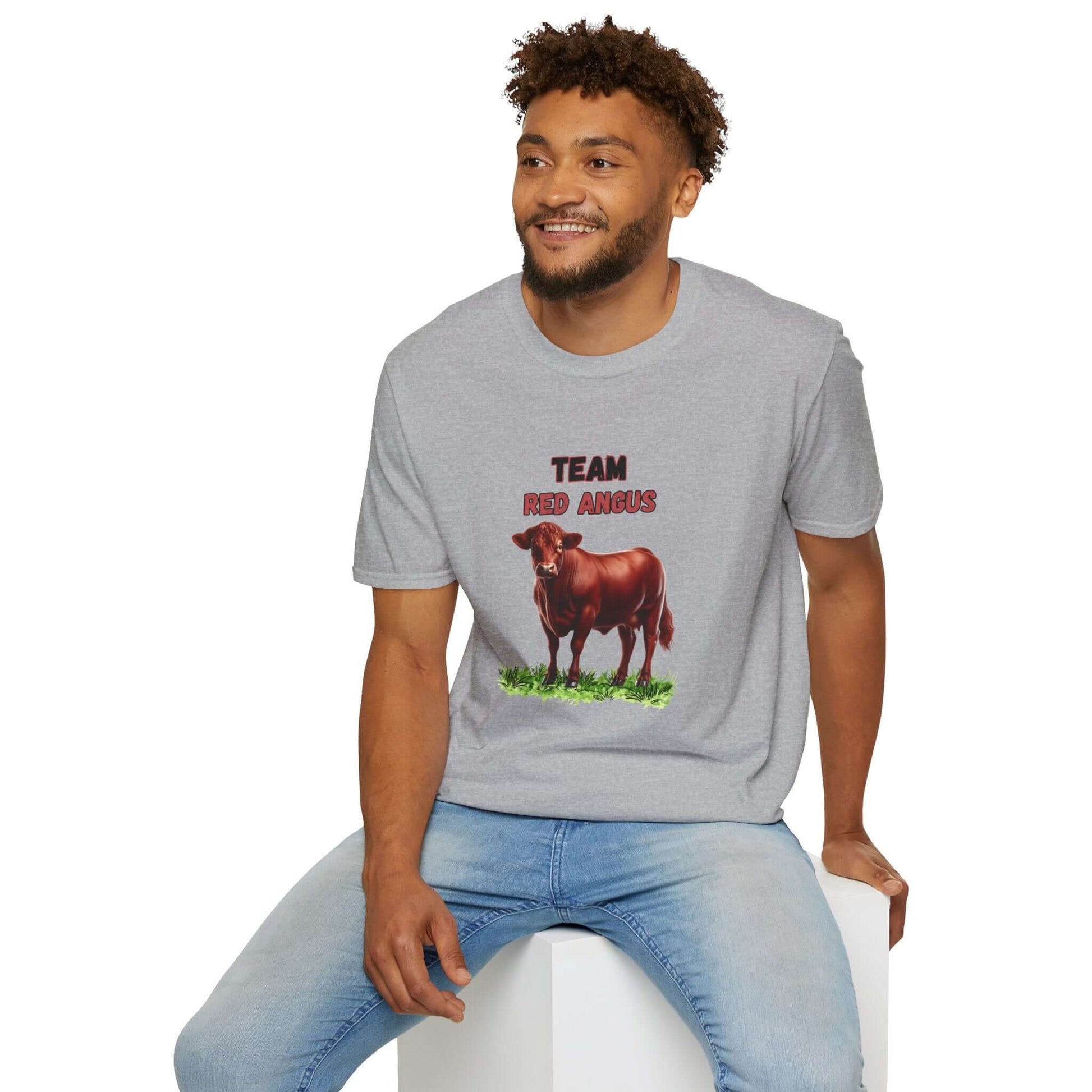 A smiling man wearing a gray Red Angus T-Shirt featuring a detailed Red Angus illustration and the text 'TEAM RED ANGUS'.
