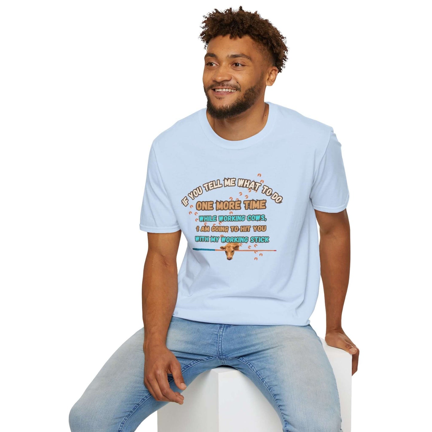 Man wearing a Working Cows Humor T-Shirt featuring a funny farm saying in a light blue color.