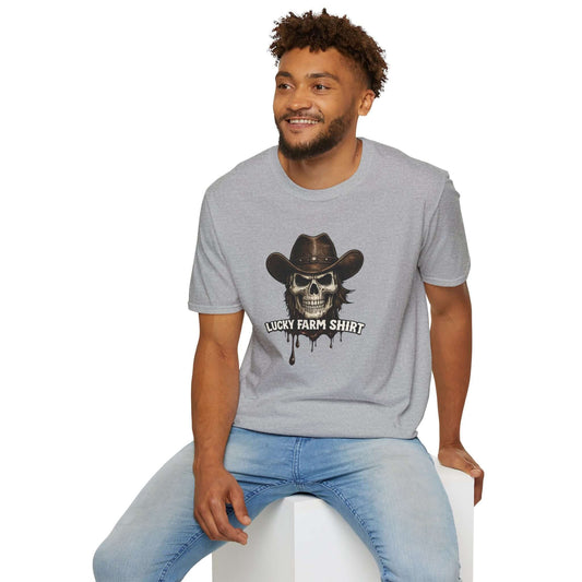Man wearing a Lucky Farm T-Shirt with a skull graphic and cowboy hat, capturing a stylish rancher vibe.