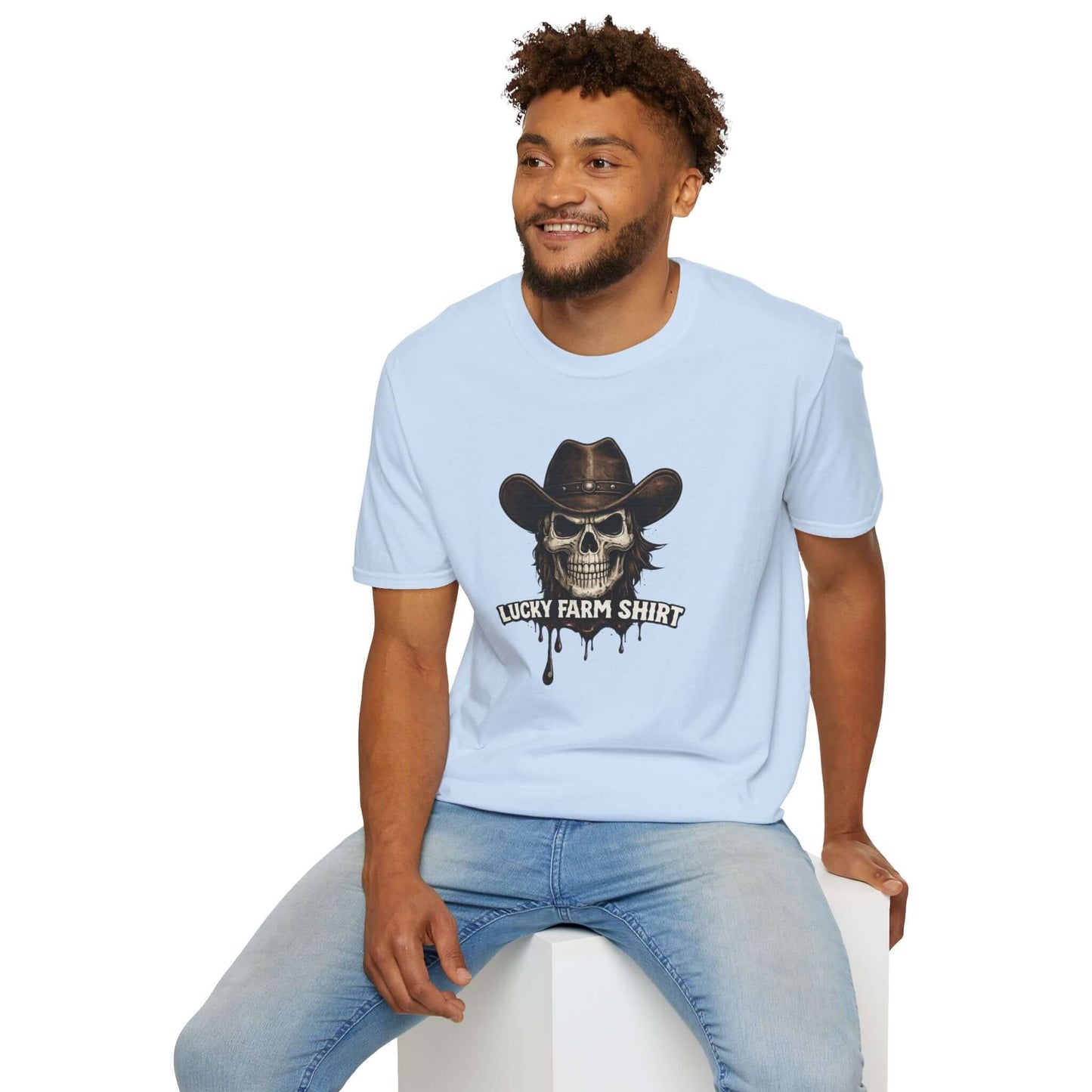 Man wearing a light blue Lucky Farm T-Shirt featuring a skull graphic with a cowboy hat and dripping ink detail.