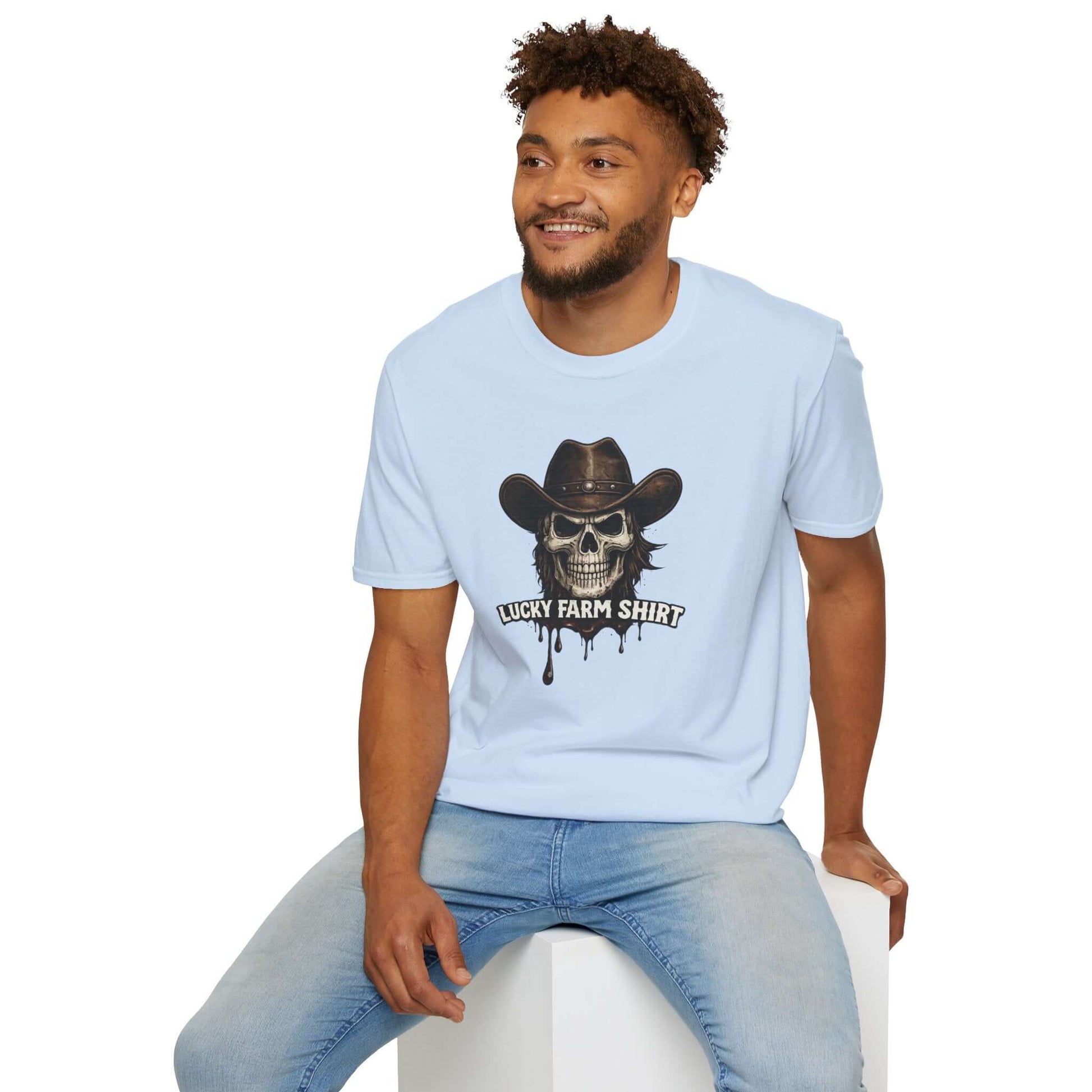Man wearing a light blue Lucky Farm T-Shirt featuring a skull graphic with a cowboy hat and dripping ink detail.