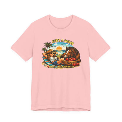 Life's A Beach Western Tee in pink featuring cowgirl, horse, palm trees, and sunset design.