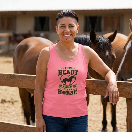 Woman wearing Horse Lover Tank Top featuring 'This Heart is Reserved for My Horse' text, with horses in the background.