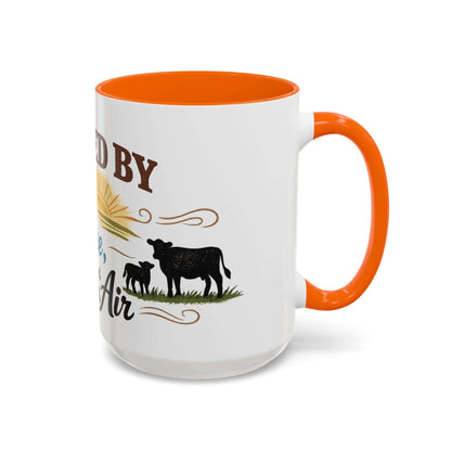 Cow Lovers Mug with graphic design of cows and sunrise, orange handle and interior, perfect for farm lovers.