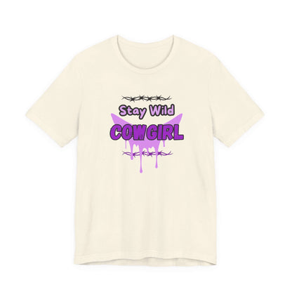 Cowgirl Western Tee featuring 'Stay Wild COWGIRL' graphic design in purple on a cream-colored t-shirt.
