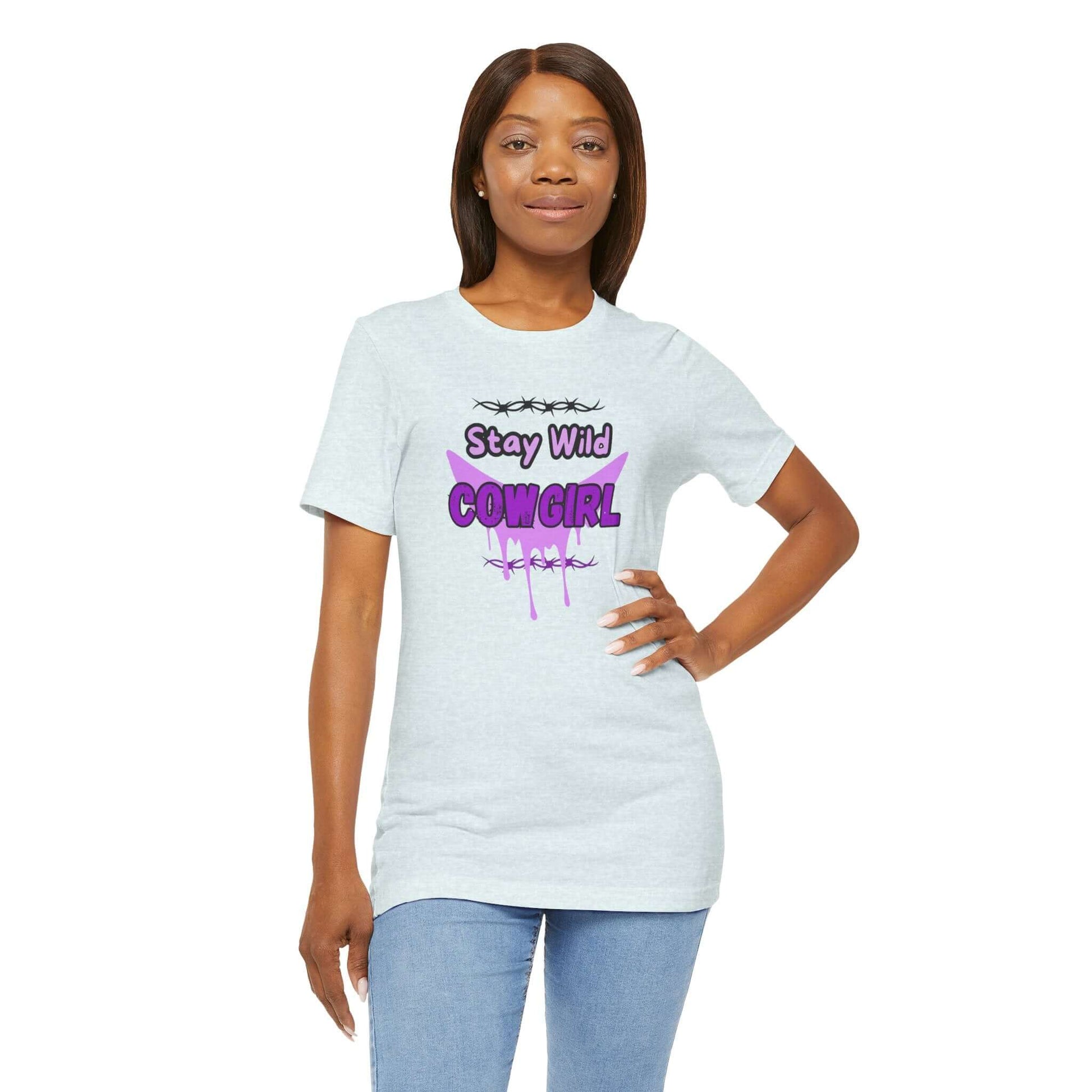 Model wearing a Cowgirl Western Tee featuring a purple graphic and the text "Stay Wild COWGIRL" on a white shirt.