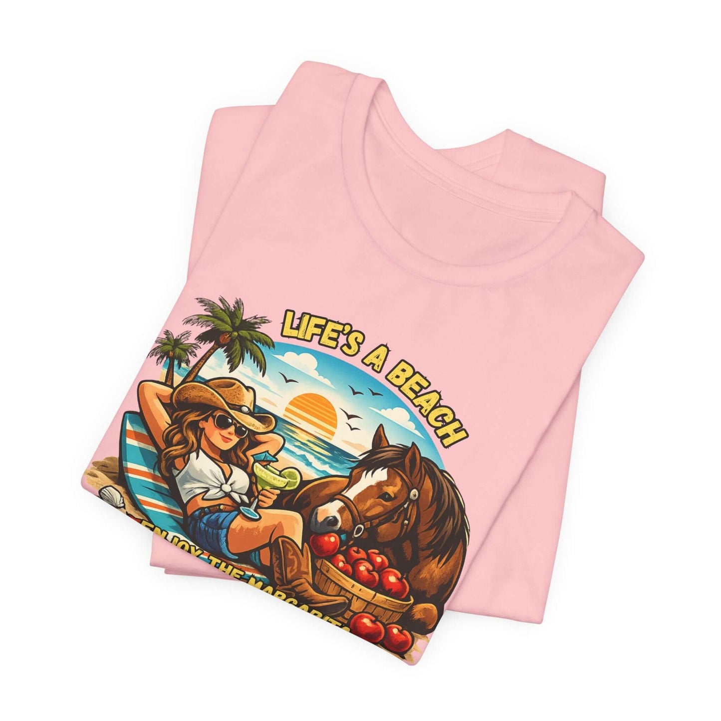 Life's A Beach Western Tee displayed in pink with sunset and beach graphic, perfect for cowgirl fashion and humor.