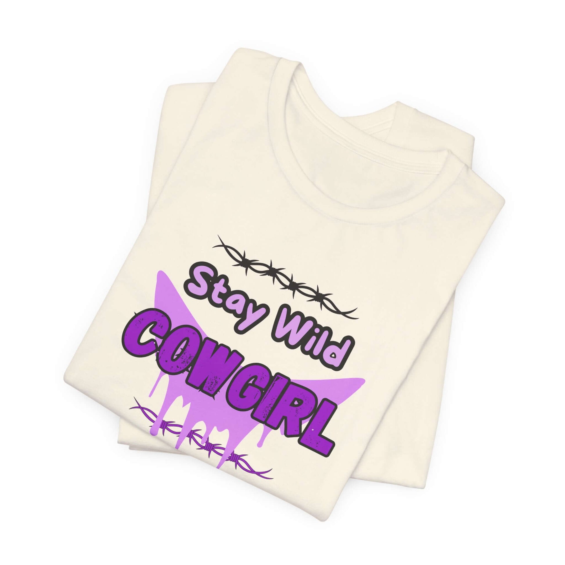 Cowgirl Western Tee featuring bold design with Stay Wild COWGIRL text and barbed wire graphic on a white shirt.