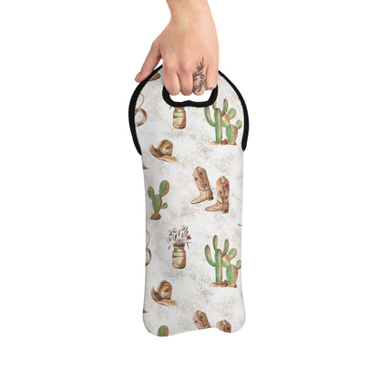 A hand holding a Cowboy Wine Bag with a rustic design featuring boots and cacti.