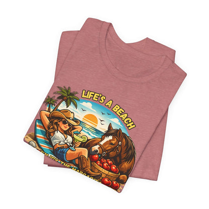 Life's A Beach Western Tee featuring a cowgirl, horse, and beach scene on a soft cotton shirt.