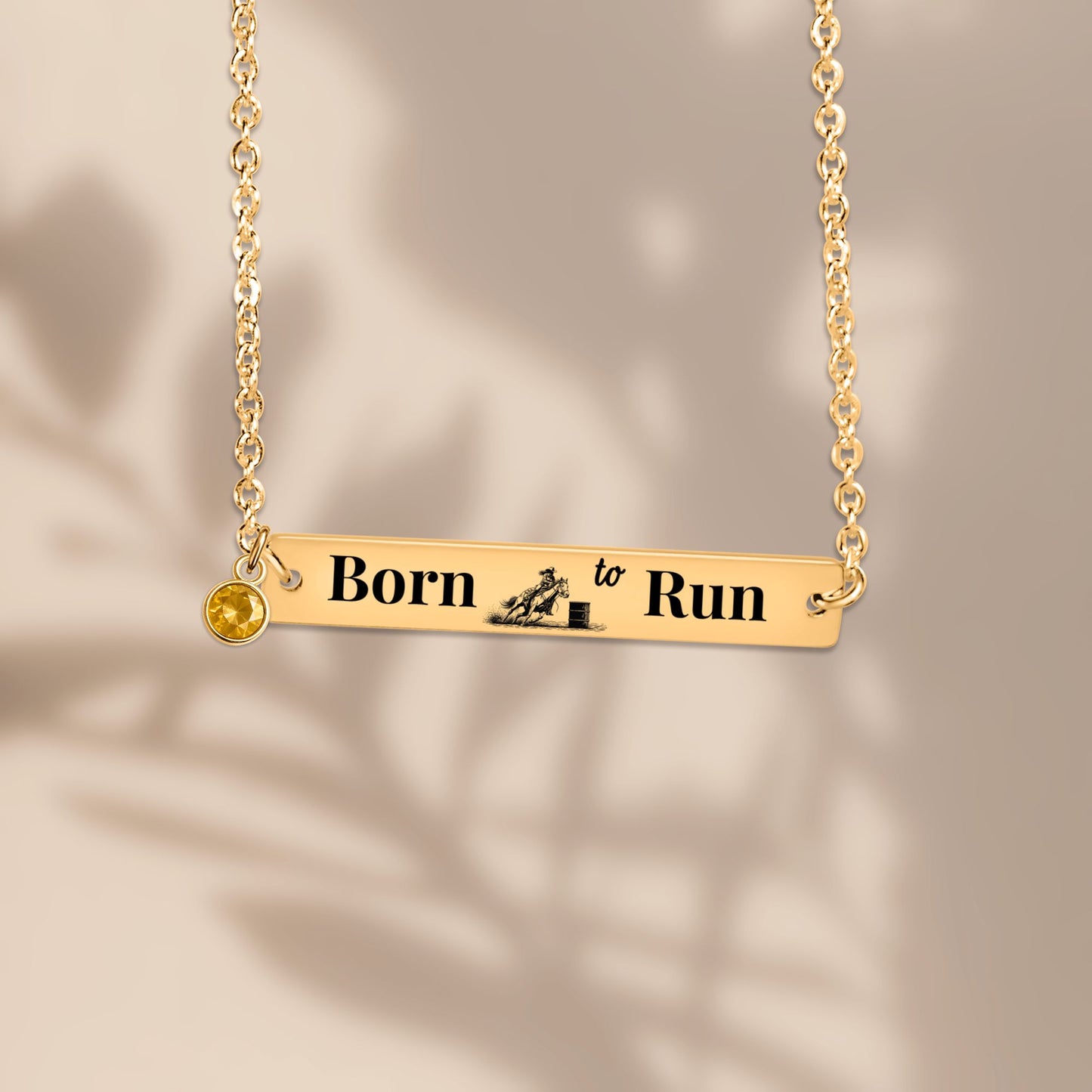 Barrel Racer Horizontal Bar Necklace with "Born to Run" engraving and birthstone charm in gold.