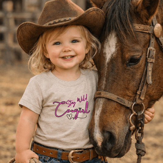 Toddler Cowgirl Tee featuring a playful design that says 'Stay Wild Cowgirl', perfect children apparel for adventure.